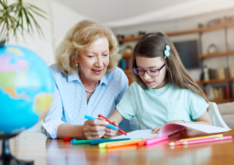 Grandma helping granddaughter with homework.
